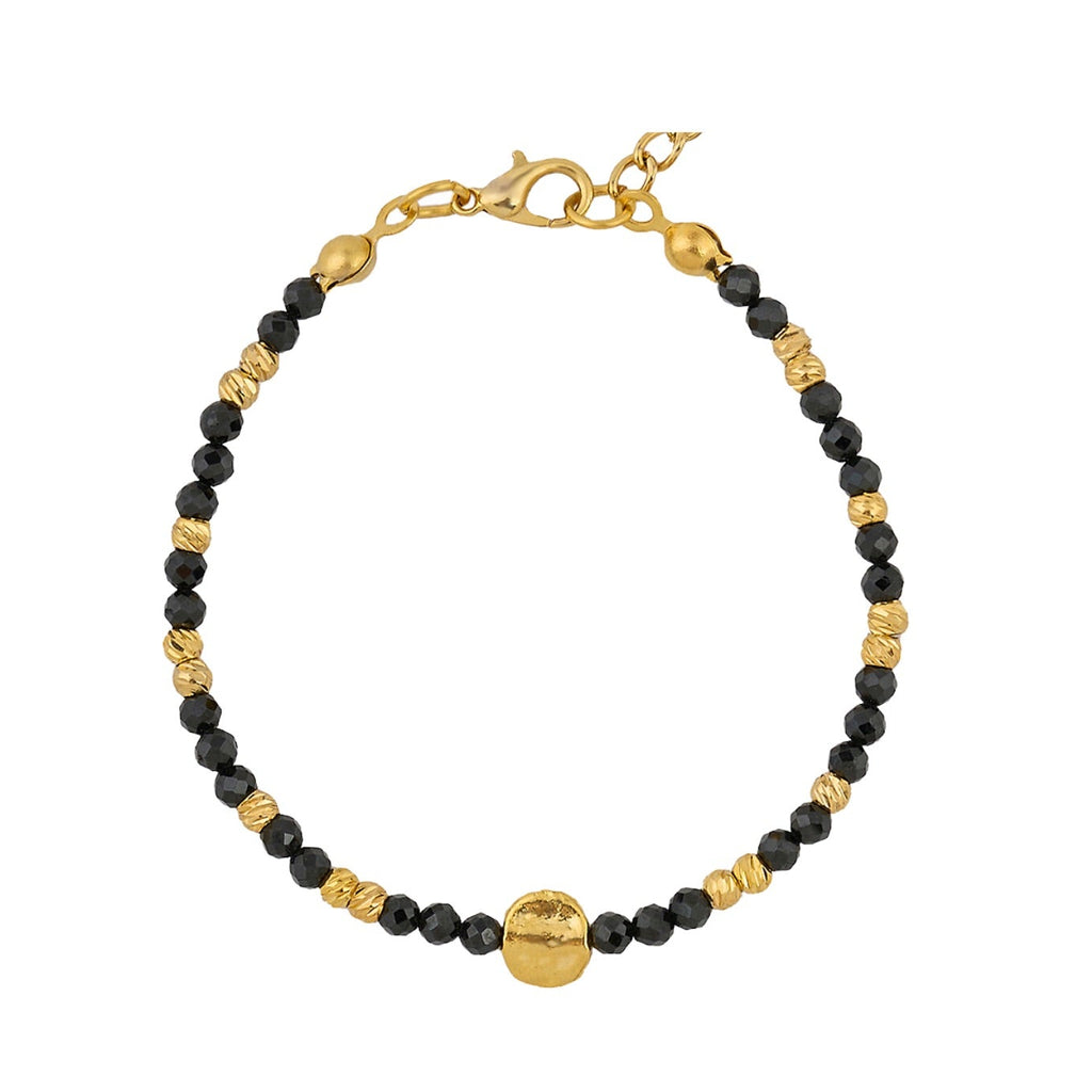 Gold and black beaded bracelet on a white background