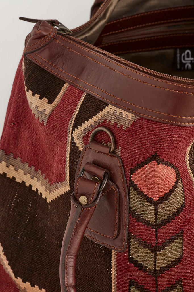 Red and brown large kilim and leather weekend bag zipper detail