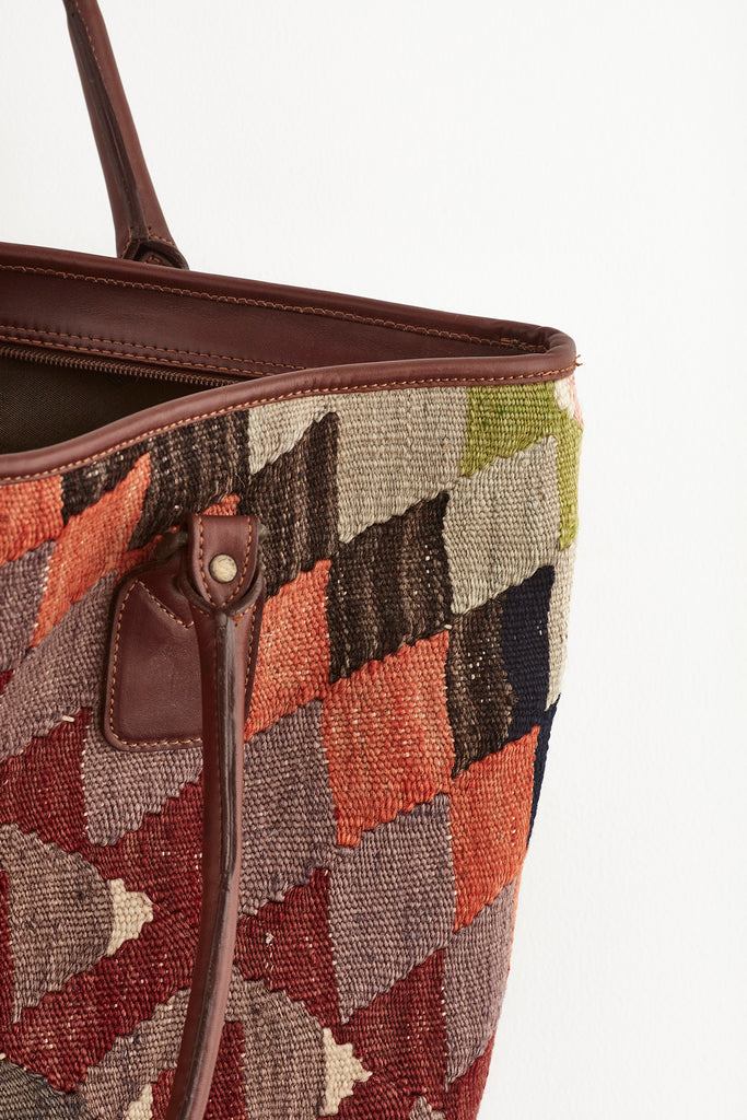 Multi coloured large kilim and leather weekend bag stitching detail